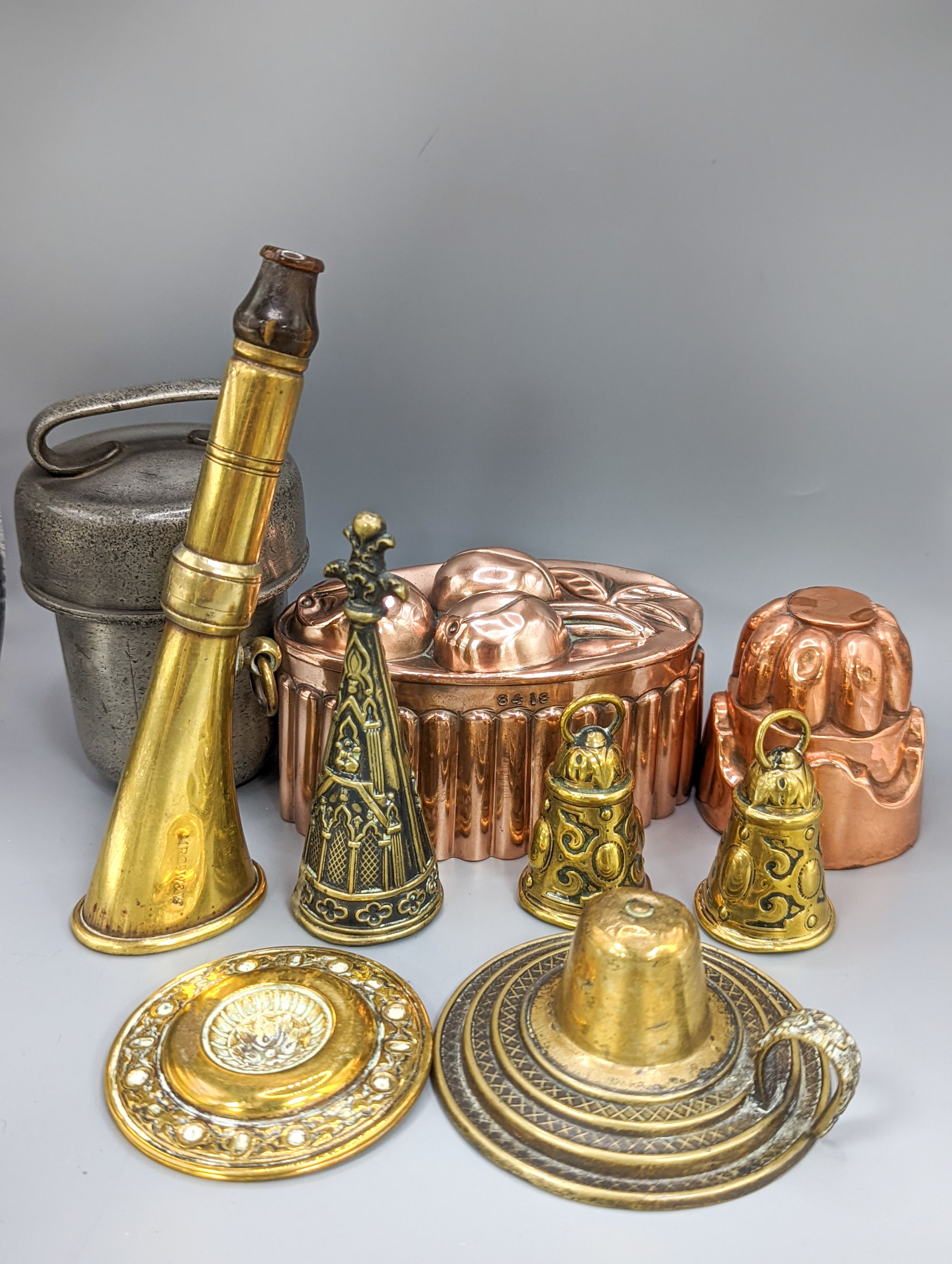 A leather cider costrel, miniature metalware including horn and two jelly moulds, brass horn, etc. and three martingales